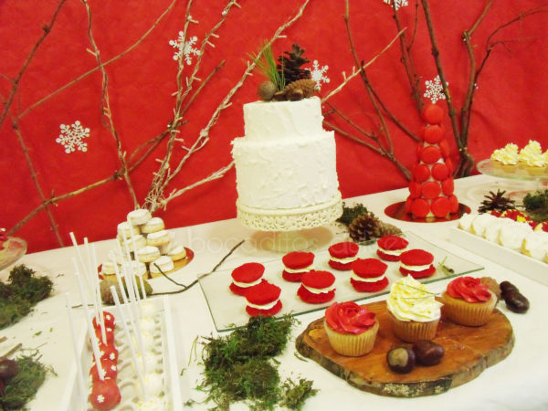mesa dulce en tonos rojos y blancos con temática de Navidad